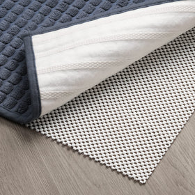 TJWODO non-slip pad in 8x10 setup stabilizes rug on hardwood floors.