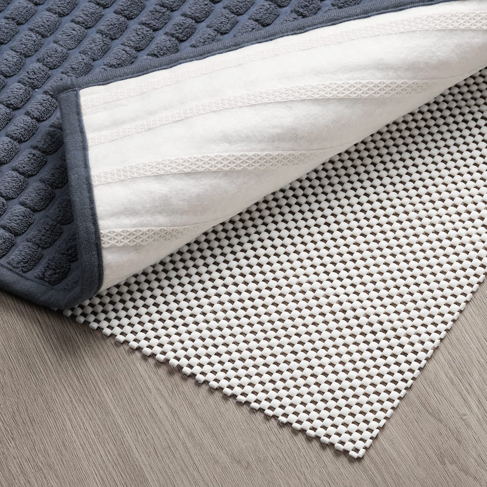 TJWODO non-slip pad in 8x10 setup stabilizes rug on hardwood floors.