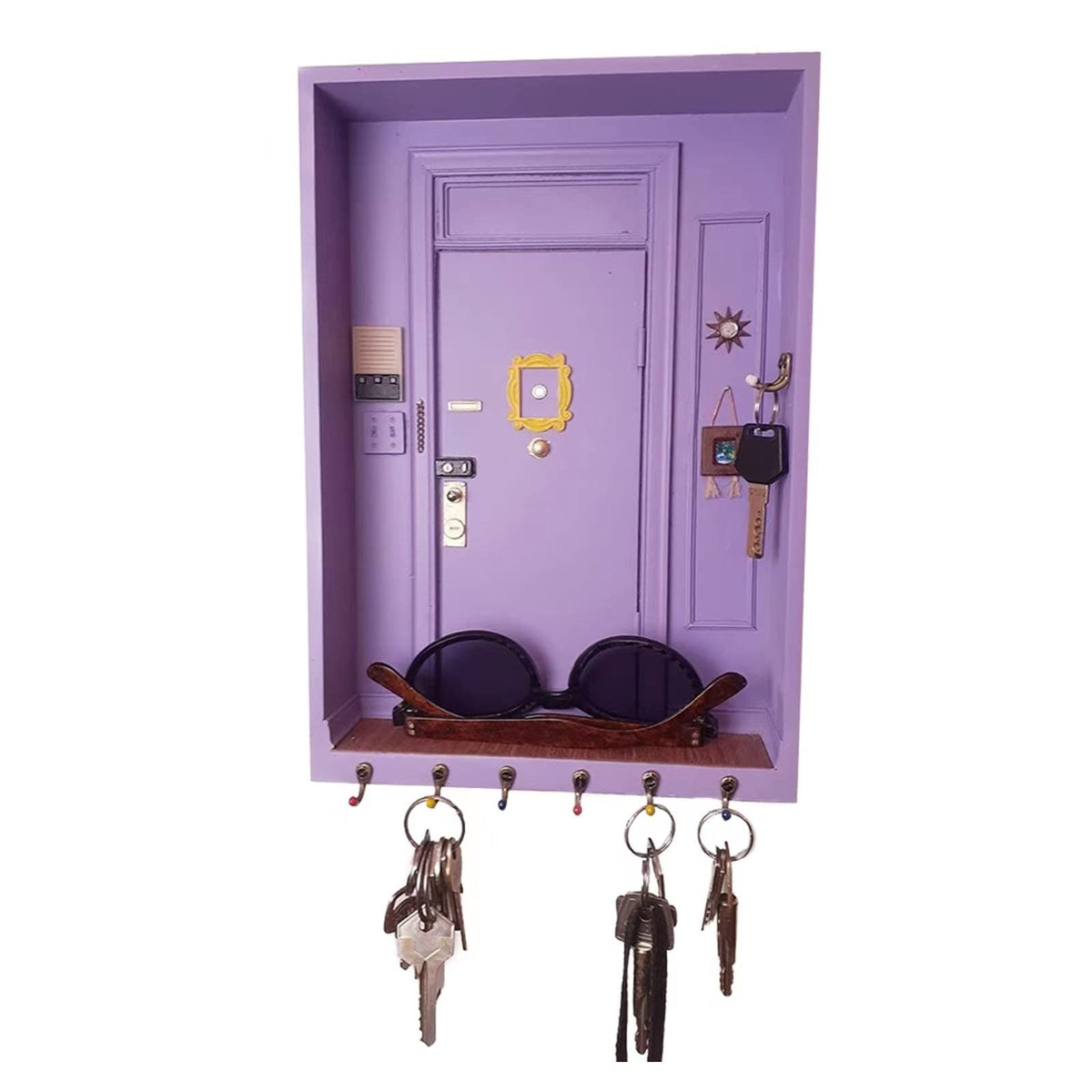 TOIVO Friends key holder on wall with six hooks to organize keys and accessories.