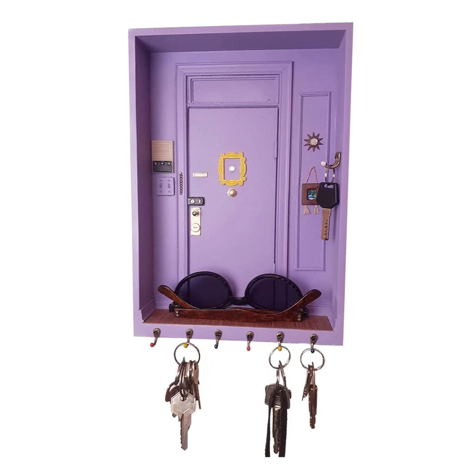 TOIVO Friends key holder on wall with six hooks to organize keys and accessories.