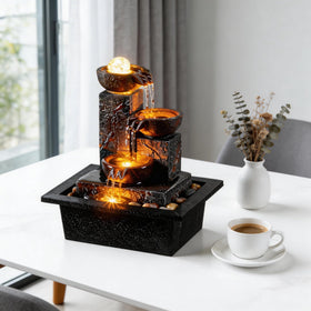 Tolevoit three-bowls fountain over pebbles adds natural texture to decor.