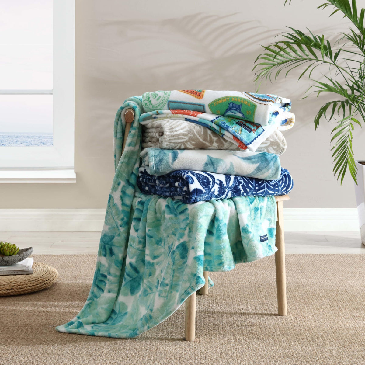 Tommy Bahama Turtle Bay Blue throw draped over a sofa for tropical vibes.