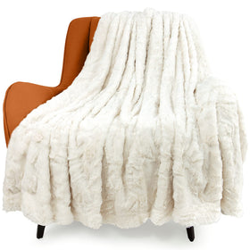 TOONOW faux fur luxury throw blanket in cream on a couch for cozy warmth.