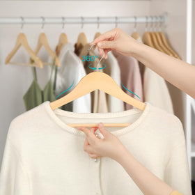 TOPIA HANGER organized closet with neatly hung outfits.