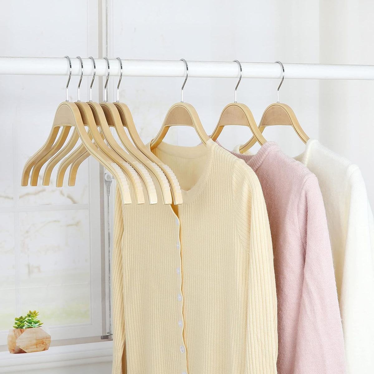 TOPIA HANGER natural wood aesthetic complements any wardrobe.