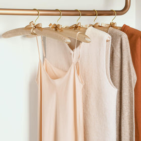 TOPIA HANGER ten-pack keeps sweaters, blouses, and dresses neatly organized.