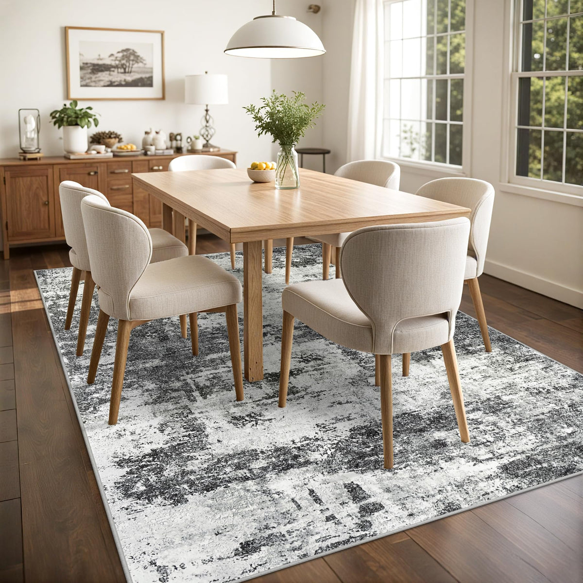 Tosuoka 8x10 abstract rug dining room arrangement under table.