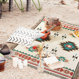 Touchat blanket folded on a chair demonstrates versatile interior decoration.