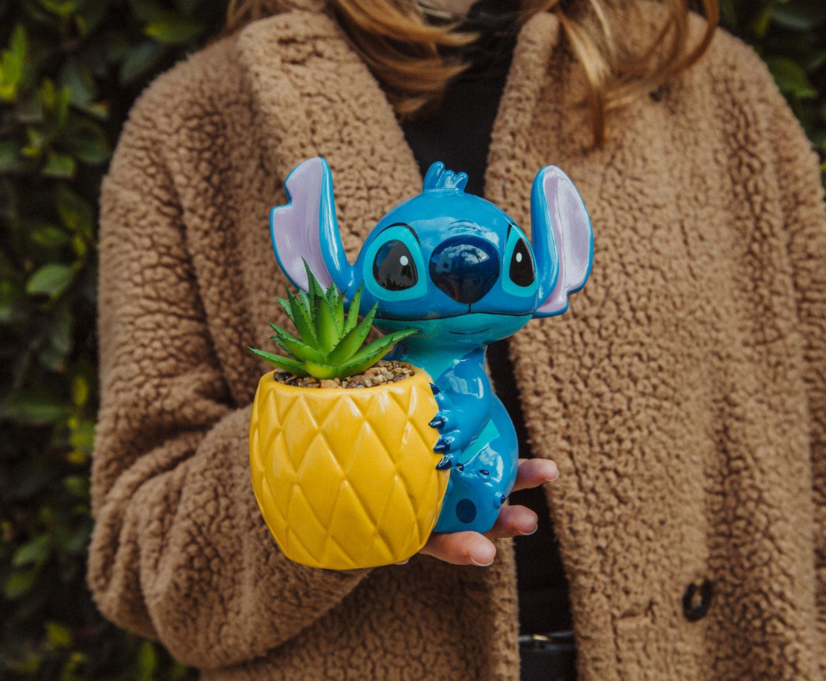 Toynk pineapple planter with Stitch creates a cheerful island vibe.