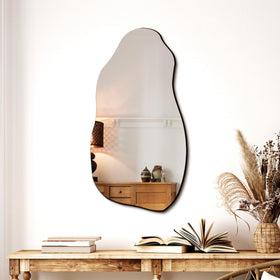 TRAHOME irregular wall mirror serves as a living room focal point.