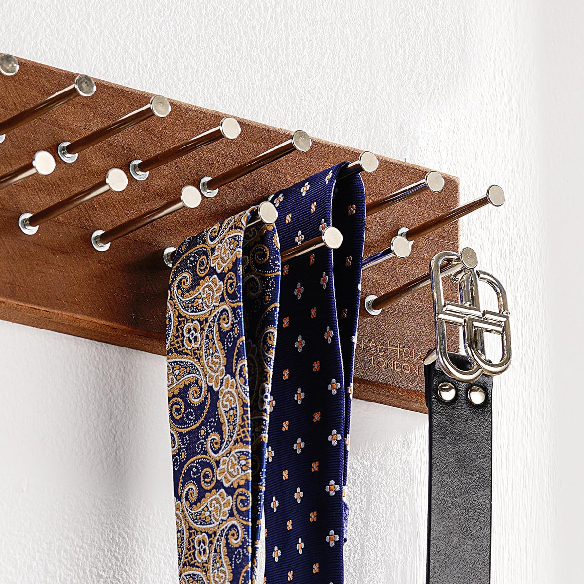 Closeup of TreeHouse London walnut finish on tie rack showing premium detail.