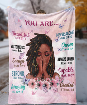 Close-up of TRENDYNEST fleece fabric and printed quotes for daily motivation.
