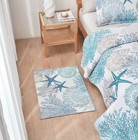 Tritard coastal pattern rug featuring stars and seashells for beachy decor.
