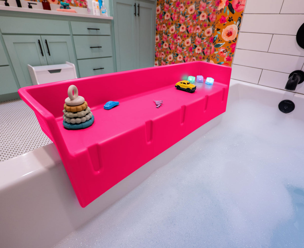 Tub Topper splash guard on tub edge keeps water contained for calmer bath time.