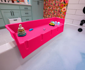 Tub Topper splash guard on tub edge keeps water contained for calmer bath time.