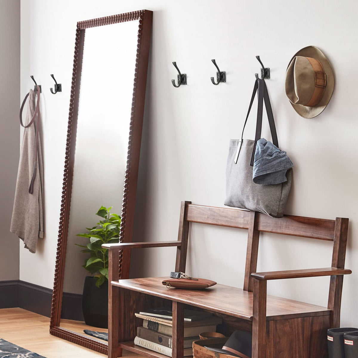 TUNNY wall-mounted hooks installed on wall for secure storage.