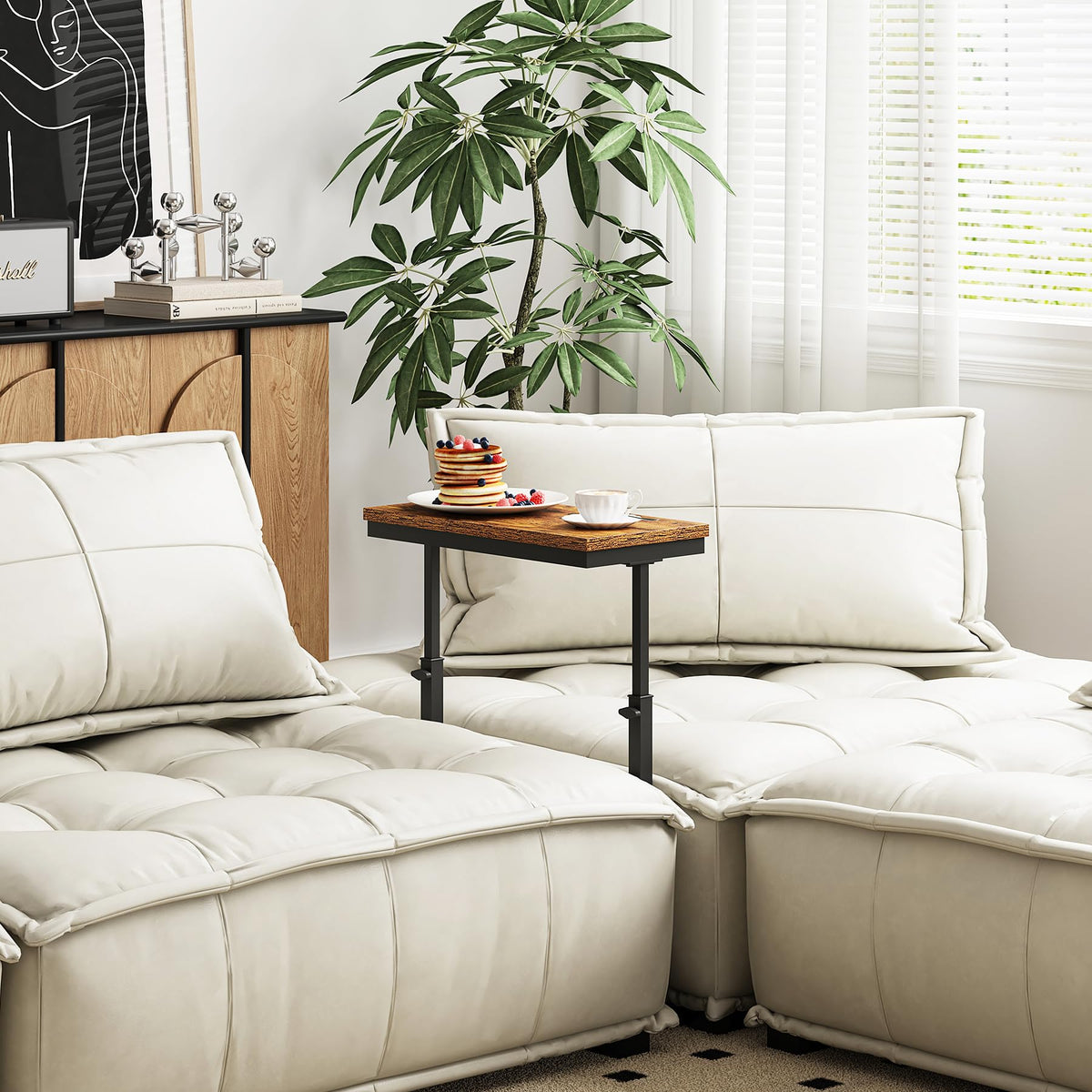 TUTOTAK tall-over-arm sofa table within reach for drinks and devices.
