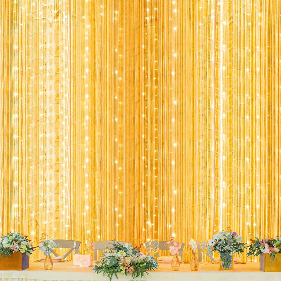 Twinkle Star 600 LED window curtain light brightens a window with cozy ambience.