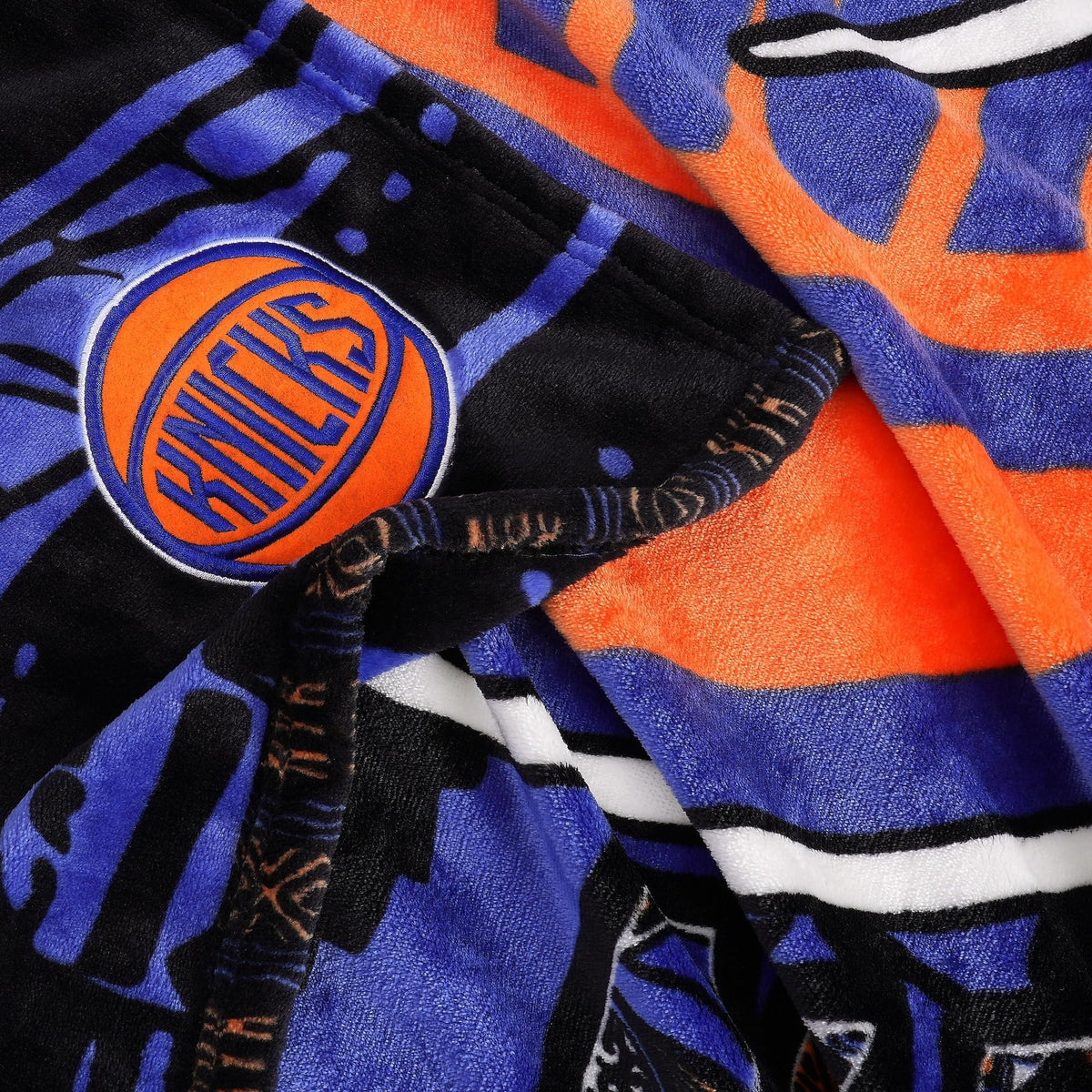 Knicks logo and team colors highlighted by Two Hype throw.