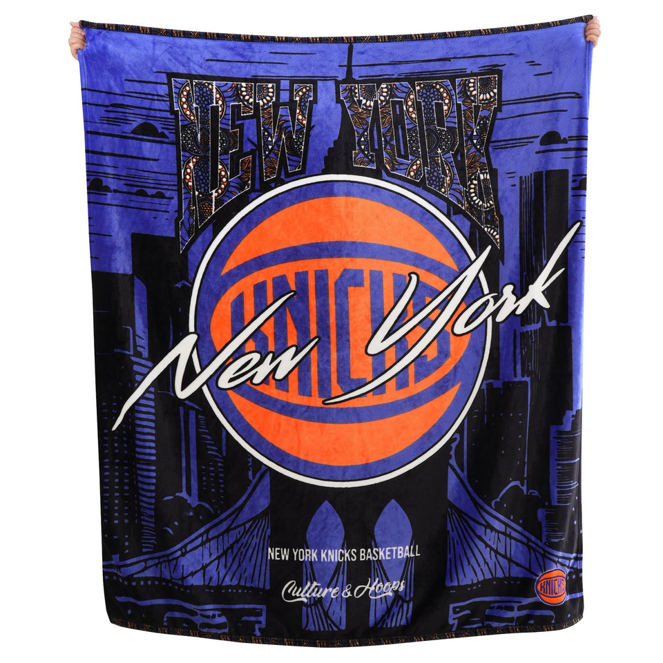 Two Hype Knicks throw blanket draped on sofa for cozy game-day warmth.