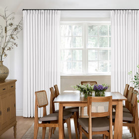 TWODRAPES ceiling-to-floor linen drape adds a luxurious room presence.