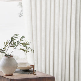 TWODRAPES privacy-friendly linen curtains soften external views and glare.
