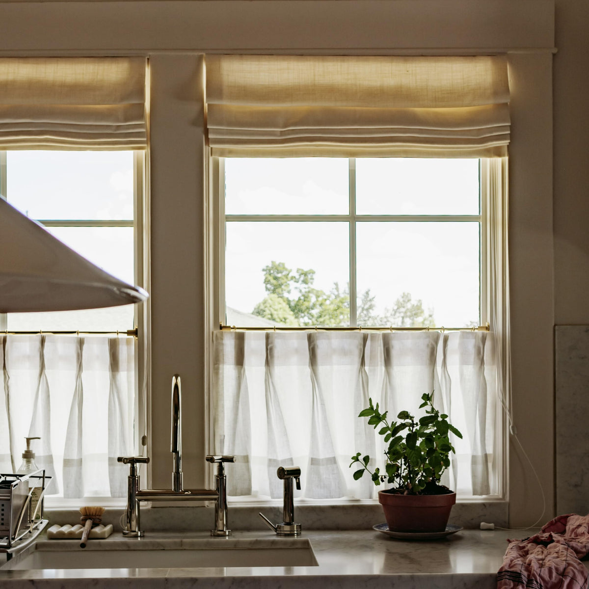 TWOPAGES Gold kitchen and bathroom decor enhances cohesive room styling.