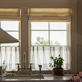 TWOPAGES Gold kitchen and bathroom decor enhances cohesive room styling.