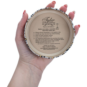 Tyler Candle Limelight on decorative shelf creates warm ambiance in living spaces.