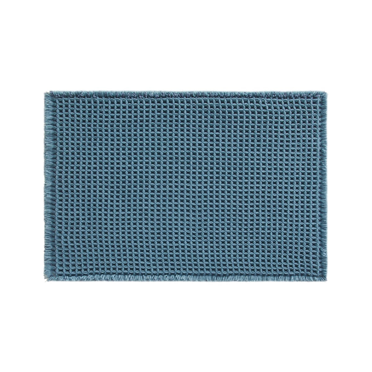 TYUU waffle bath mat denim blue stacked for storage after use.