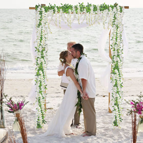 U'Artlines wisteria garland on an arch, draped gracefully for wedding backdrop