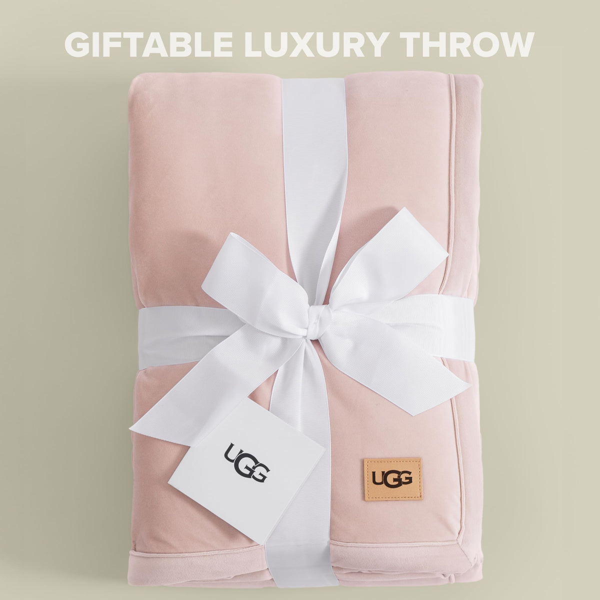 UGG Bliss Throw Blanket on bed adds soft texture and warmth.