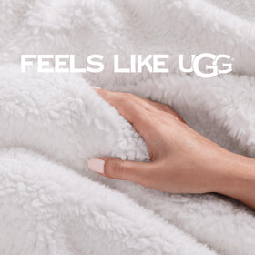 UGG Bliss Throw Blanket on couch enhances room texture and coziness.