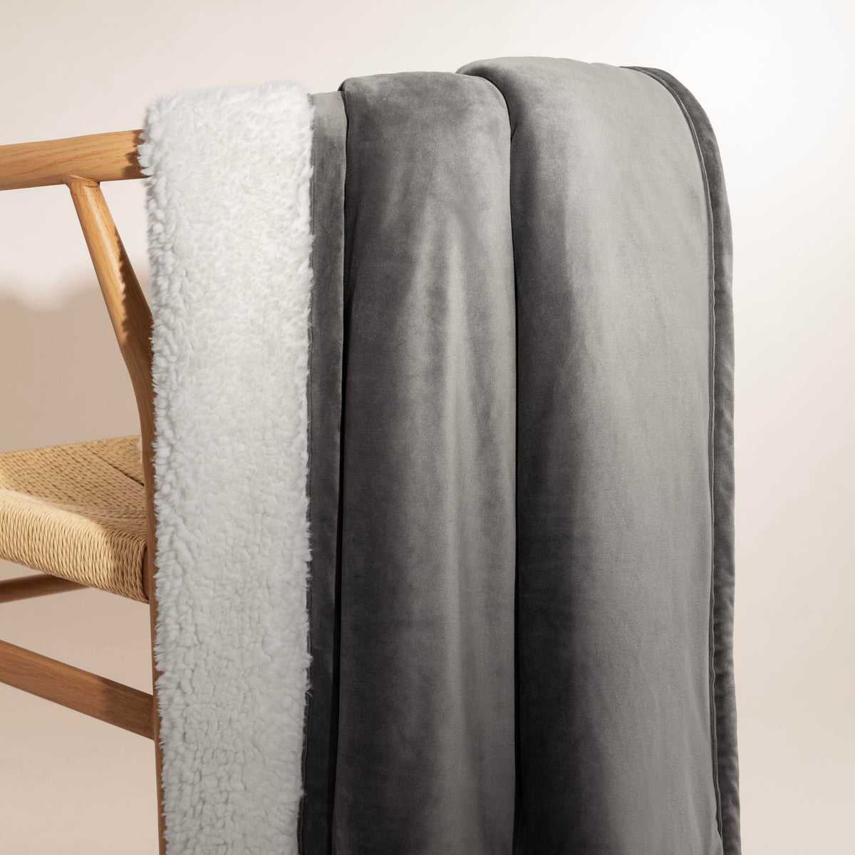 UGG Bliss Throw Blanket draped on sofa invites easy relaxation.