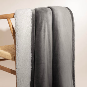 UGG Bliss Throw Blanket draped on sofa invites easy relaxation.