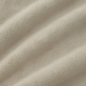 Decor-friendly Coco fleece blanket in ivory enhances living room ambience.