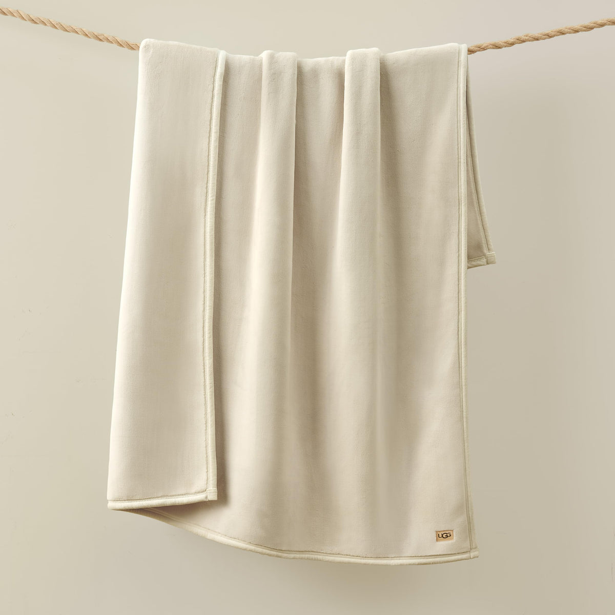 Unfolded Coco blanket on couch invites warmth during chilly nights.