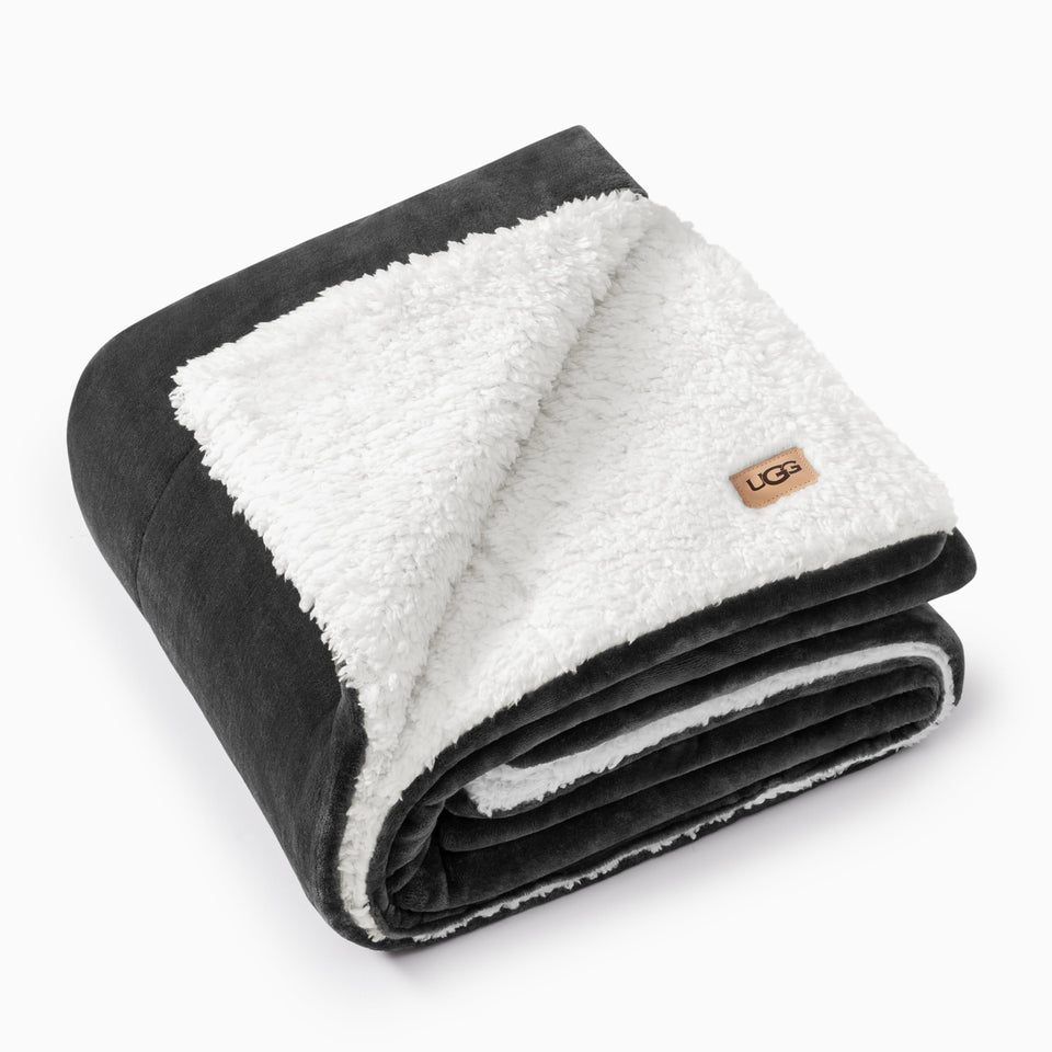 UGG Nita throw blanket with box stitching adds cozy texture to bed or sofa.