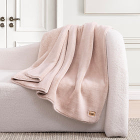 UGG Whitecap throw on bed adds soft pink decor and cozy layering.