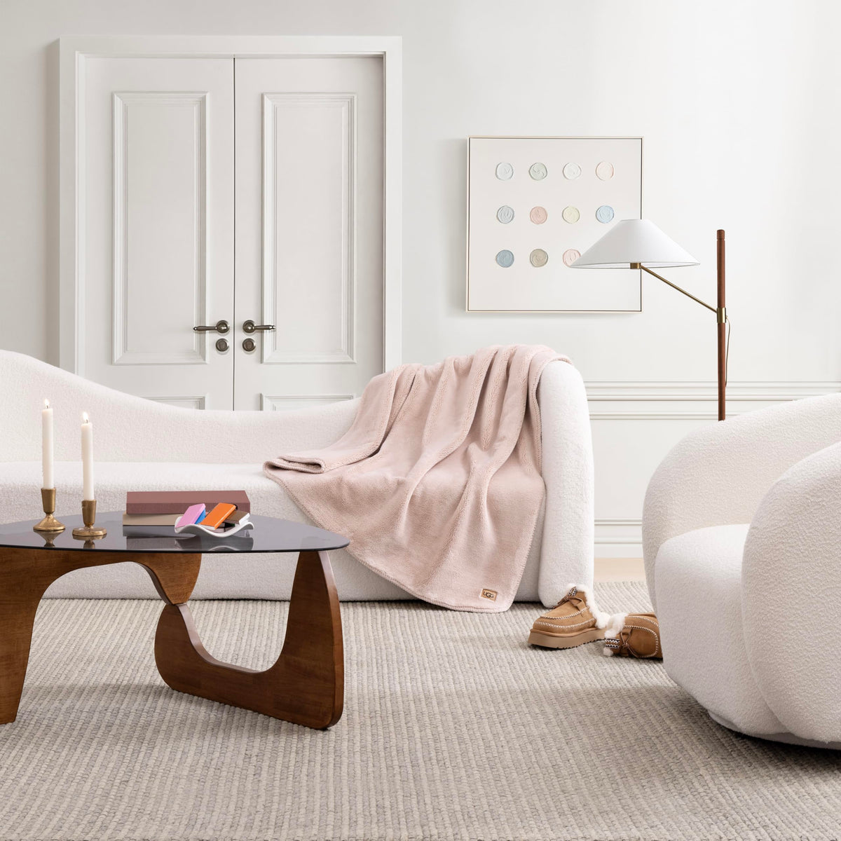 UGG Whitecap throw draped on a chair enhances modern bedroom decor.