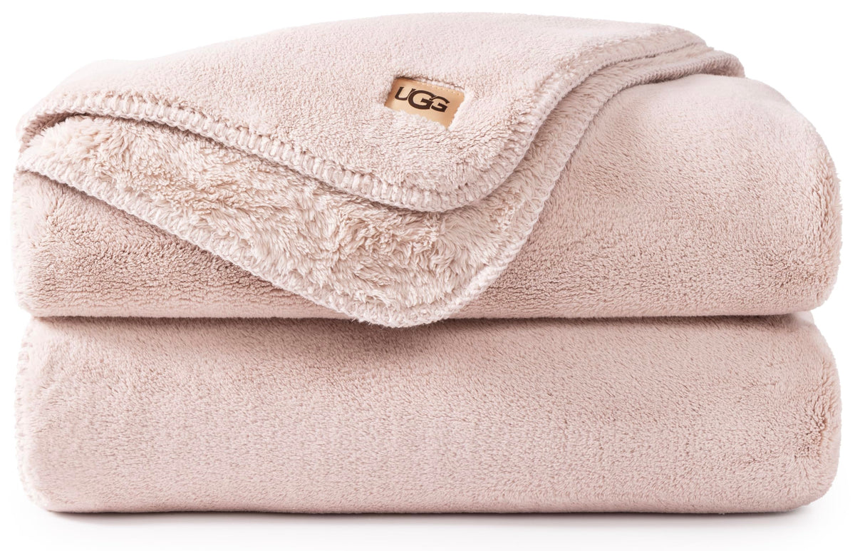 UGG Whitecap throw pink quartz fabric closeup highlighting plush warmth.