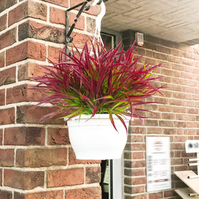 Uieke spring and summer decor on the front porch with faux greenery.