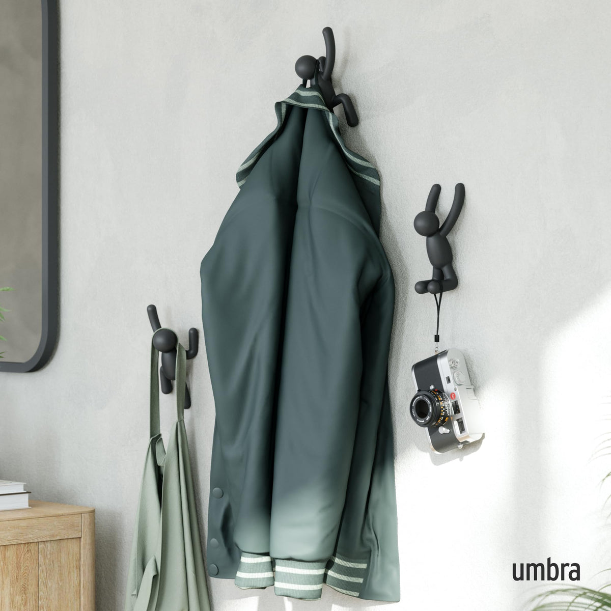 Umbra Buddy wall hooks mounted neatly for a clutter-free wall.