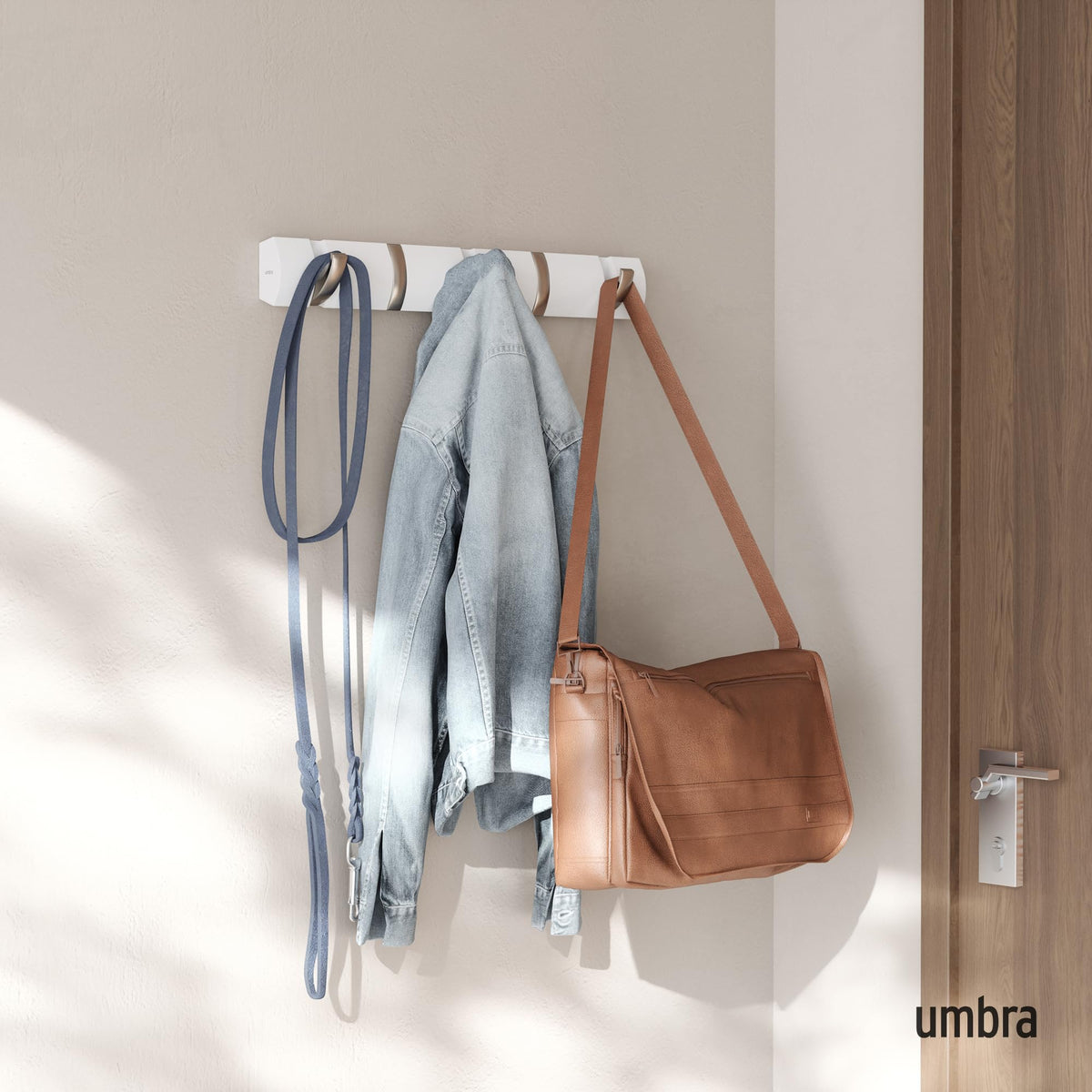 Close-up of Umbra Flip retractable hooks showing smooth operation.