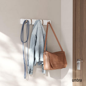 Close-up of Umbra Flip retractable hooks showing smooth operation.