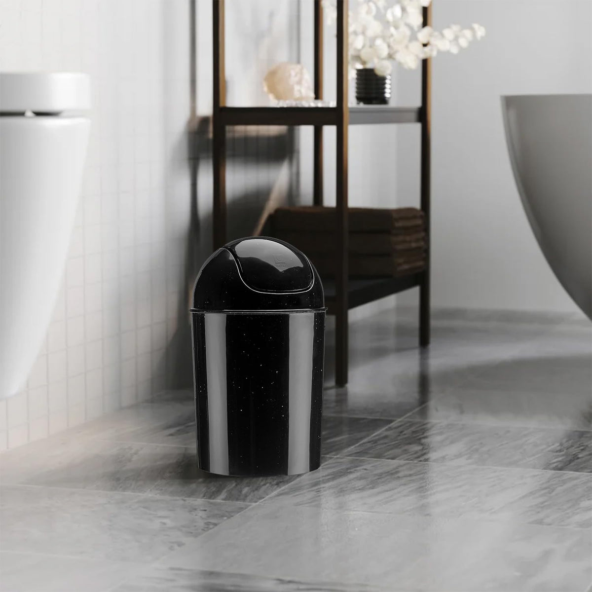 Umbra mini waste can under-cabinet demonstrates compact storage.