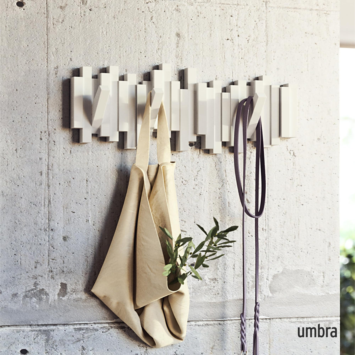Umbra Sticks retractable hooks extended demonstrate five-hook capacity for coats and bags