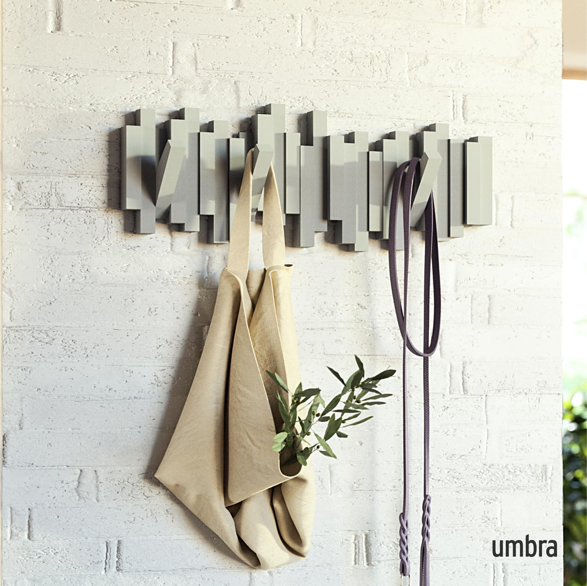 Umbra Sticks five retractable pegs provide flexible hanging space for coats and bags
