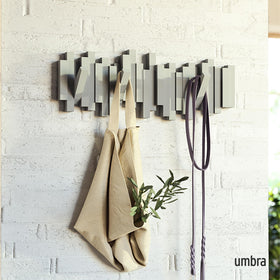 Umbra Sticks five retractable pegs provide flexible hanging space for coats and bags