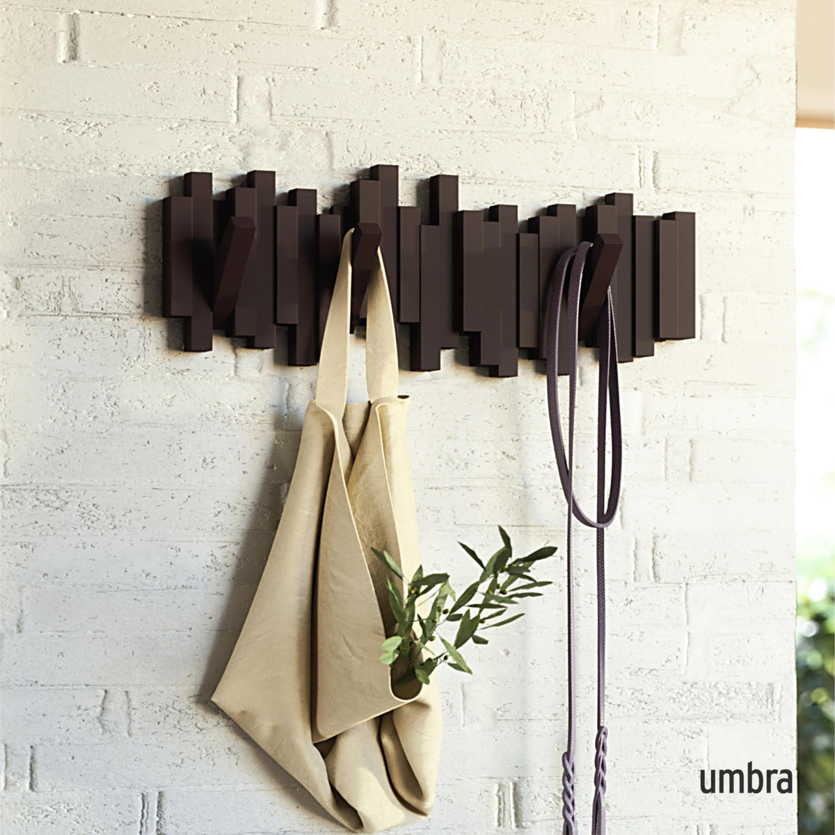 Umbra Sticks retractable pegs coat hanger offering flexible storage for coats and bags.